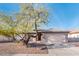 Charming home exterior with desert landscaping and a two-car garage at 16292 N Naegel Dr, Surprise, AZ 85374