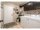 Functional laundry room with a washer, dryer, and ample storage shelves at 16292 N Naegel Dr, Surprise, AZ 85374