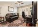 Comfortable office space with a leather couch, shuttered window, and an area rug at 16292 N Naegel Dr, Surprise, AZ 85374