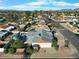 An aerial view shows a single story home with desert landscaping in a residential neighborhood at 17234 N Paradise Park Dr, Phoenix, AZ 85032