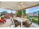 Inviting covered patio with ample seating and a view of the beautifully landscaped backyard with a play area at 17234 N Paradise Park Dr, Phoenix, AZ 85032