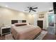 Comfortable bedroom with a bed, ceiling fan, side tables, and a view into an adjacent sitting room at 17234 N Paradise Park Dr, Phoenix, AZ 85032