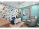 Charming ' bedroom with dinosaur-themed wallpaper, a cozy bed, and a comfortable armchair at 17234 N Paradise Park Dr, Phoenix, AZ 85032