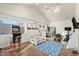 Bonus room with vaulted ceilings, game table, and natural light from the large window and skylight at 17234 N Paradise Park Dr, Phoenix, AZ 85032