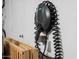 An EV charger is mounted on the wall next to a foldable wooden baby crib at 17234 N Paradise Park Dr, Phoenix, AZ 85032