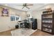 Home office space with a workstation, built-in shelving, and a ceiling fan for a comfortable workspace at 17234 N Paradise Park Dr, Phoenix, AZ 85032
