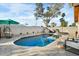 Private backyard pool oasis with lounge seating and lush landscaping for ultimate relaxation and leisure at 17234 N Paradise Park Dr, Phoenix, AZ 85032