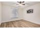 Inviting bedroom features wood-look flooring, ceiling fan and a bright window at 1949 E Oxford Dr, Tempe, AZ 85283