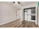 Bright bedroom boasts wood-look laminate flooring and convenient closet organizer system at 1949 E Oxford Dr, Tempe, AZ 85283