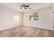 Minimalist bedroom with light flooring, ceiling fan, and bright natural light at 1949 E Oxford Dr, Tempe, AZ 85283