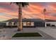Charming single-story home with a well-manicured yard, desert landscaping, and modern garage door at 1949 E Oxford Dr, Tempe, AZ 85283