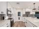 Modern kitchen featuring gray backsplash, white countertops and cabinets, and stainless steel appliances at 1949 E Oxford Dr, Tempe, AZ 85283