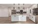 Modern kitchen with stainless steel appliances, white cabinets, and a spacious island at 1949 E Oxford Dr, Tempe, AZ 85283