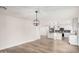 Open concept kitchen and living area with modern pendant lighting and stainless steel appliances at 1949 E Oxford Dr, Tempe, AZ 85283
