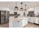 Updated kitchen featuring stainless steel appliances, sleek white cabinetry, and a large kitchen island at 1949 E Oxford Dr, Tempe, AZ 85283