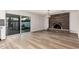 Open-concept living space with wood-look flooring, fireplace, and backyard access at 1949 E Oxford Dr, Tempe, AZ 85283