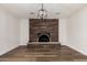 Living room area highlighting brick fireplace and decorative modern lighting at 1949 E Oxford Dr, Tempe, AZ 85283