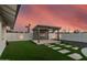 Stylish backyard lounge area featuring modern design and beautiful landscaping, with pavers on artificial turf at 1949 E Oxford Dr, Tempe, AZ 85283