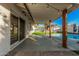 Spacious covered patio with wood beam accents, offering seamless indoor-outdoor living with a view of the pool at 1949 E Oxford Dr, Tempe, AZ 85283