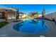 Inviting backyard oasis featuring a sparkling pool, comfortable lounge area, and well-manicured landscaping at 1949 E Oxford Dr, Tempe, AZ 85283