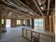 Unfinished living room under construction with sliding glass doors, and exposed framing, and unfinished ceilings at 1970 W Lariat Ln, Phoenix, AZ 85085