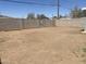 Expansive dirt backyard with a cinderblock perimeter fence, presenting ample space for various outdoor activities and landscaping at 2010 N 38Th Ave, Phoenix, AZ 85009