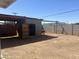 Vast dirt backyard featuring a cinderblock fence and shed, providing privacy and storage, with lots of potential at 2010 N 38Th Ave, Phoenix, AZ 85009