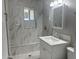 Bathroom features white marble tiling in the shower and floors, with a modern sink and vanity at 2010 N 38Th Ave, Phoenix, AZ 85009