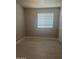 A serene bedroom featuring neutral walls, tiled floors, and a bright window, ready for personalization and comfort at 2010 N 38Th Ave, Phoenix, AZ 85009