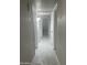 Hallway with multiple doors, tile flooring and textured walls at 2010 N 38Th Ave, Phoenix, AZ 85009