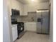 Modern kitchen features white cabinets, stainless steel appliances, and a stylish marble backsplash at 2010 N 38Th Ave, Phoenix, AZ 85009