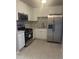 Bright kitchen boasts stainless steel appliances, white cabinetry and a marble-patterned backsplash at 2010 N 38Th Ave, Phoenix, AZ 85009