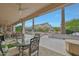 Covered patio features multiple outdoor seating areas, dining space and well-maintained landscaping at 20416 N Palm Canyon Dr, Surprise, AZ 85374