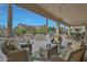 Relaxing covered patio includes outdoor seating, a dining area, and a built-in water feature at 20416 N Palm Canyon Dr, Surprise, AZ 85374