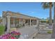 The expansive covered patio has seating, dining and decorative features under a blue sky at 20416 N Palm Canyon Dr, Surprise, AZ 85374