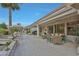 The covered patio includes a dining and seating area, lush landscaping, and a water feature at 20416 N Palm Canyon Dr, Surprise, AZ 85374