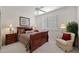 Bedroom featuring a wood sleigh bed, shuttered windows, ceiling fan and bedside tables with lamps at 20416 N Palm Canyon Dr, Surprise, AZ 85374