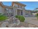 A beautiful front entrance with double glass doors and desert landscaping at 20416 N Palm Canyon Dr, Surprise, AZ 85374