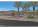 Well-maintained home featuring desert landscaping and a three car garage at 20416 N Palm Canyon Dr, Surprise, AZ 85374