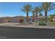 Well-maintained home featuring desert landscaping and a three car garage at 20416 N Palm Canyon Dr, Surprise, AZ 85374