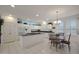 Bright kitchen with white cabinetry, granite countertops, large island, and adjacent dining area under chandelier at 20416 N Palm Canyon Dr, Surprise, AZ 85374