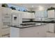 Beautiful kitchen featuring white cabinets, granite countertops, stainless steel appliances, and central cooktop island at 20416 N Palm Canyon Dr, Surprise, AZ 85374