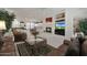 Bright living room with fireplace, TV, and cozy seating, seamlessly connected to the kitchen area at 20416 N Palm Canyon Dr, Surprise, AZ 85374