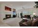 Spacious living room featuring a fireplace, entertainment center, and comfortable seating, filled with natural light at 20416 N Palm Canyon Dr, Surprise, AZ 85374