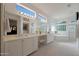 Luxurious bathroom featuring double sinks, a soaking tub, a separate shower, and ample natural light at 20416 N Palm Canyon Dr, Surprise, AZ 85374