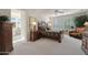 Serene main bedroom featuring a plush bed, ample natural light, and a glimpse of an en-suite bathroom at 20416 N Palm Canyon Dr, Surprise, AZ 85374
