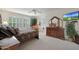 Bright main bedroom featuring large windows, plush furniture, and serene decor, creating a relaxing retreat at 20416 N Palm Canyon Dr, Surprise, AZ 85374