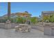Secluded patio features tiled flooring, stone picnic table with umbrella, and fountain feature at 20416 N Palm Canyon Dr, Surprise, AZ 85374