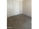 Comfortable bedroom with wood-look tile flooring and closet at 20625 N 104Th Ave, Peoria, AZ 85382