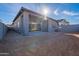 Beautiful home exterior with a covered patio and sliding glass doors, offering seamless indoor-outdoor living at 21422 W Meadowbrook Ave, Buckeye, AZ 85396